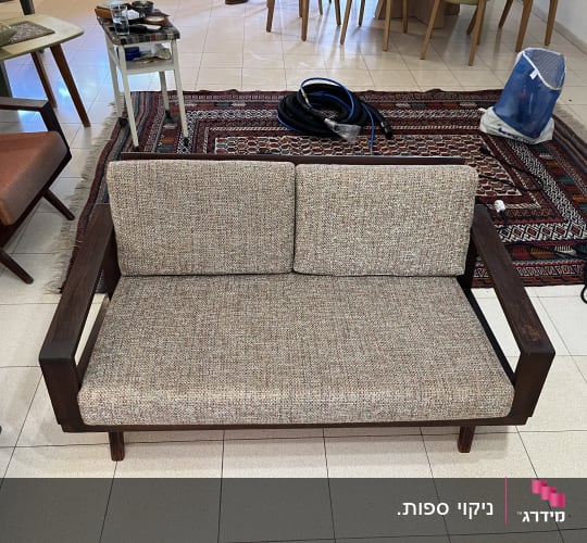 ספה עם ציוד ניקוי על שטיח